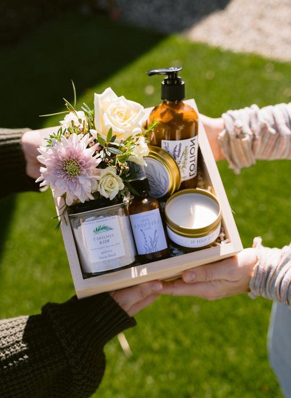 Two hands holding Riviera Garden Gift Box with Flowers